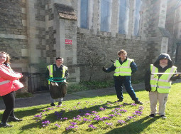 Uplands Enterprise Trust litter pickers on the grassy grounds of a church
