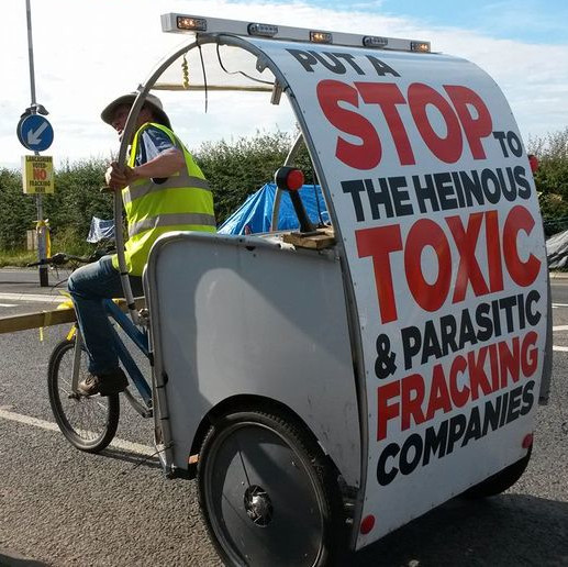Tuk tuk at what seems to be an anti-fracking encampment.  The message on the back reads: 'Put a stop to the heinous, toxic, and parasitic fracking companies'