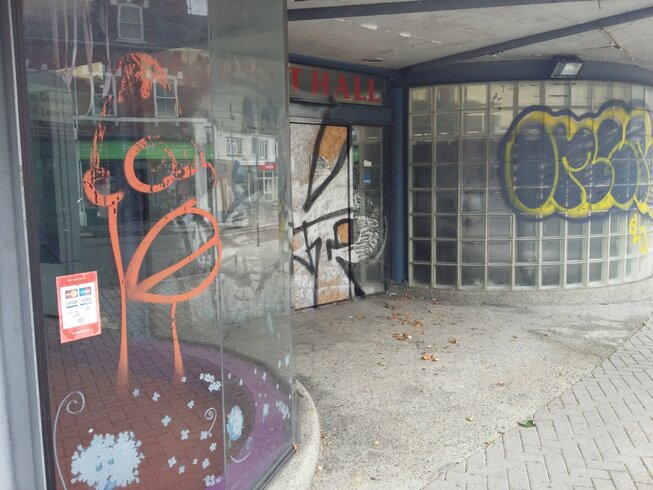 Swindon's closed and run down tented market.  Windows and doors are covered in graffiti