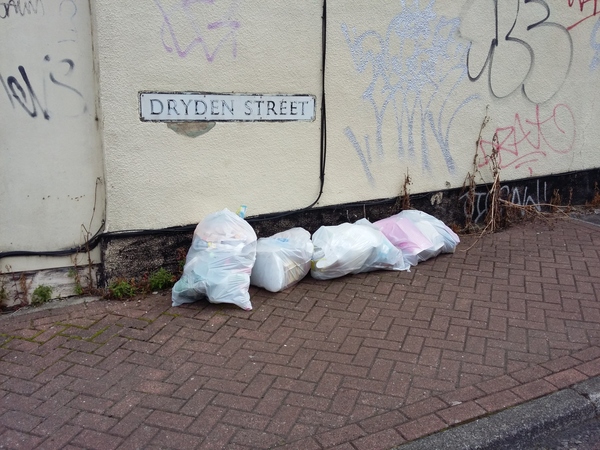 Piles of rubbish left on the pavement close to Cambria Bridge