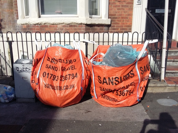 Builders bags tied to railings to store rubbish