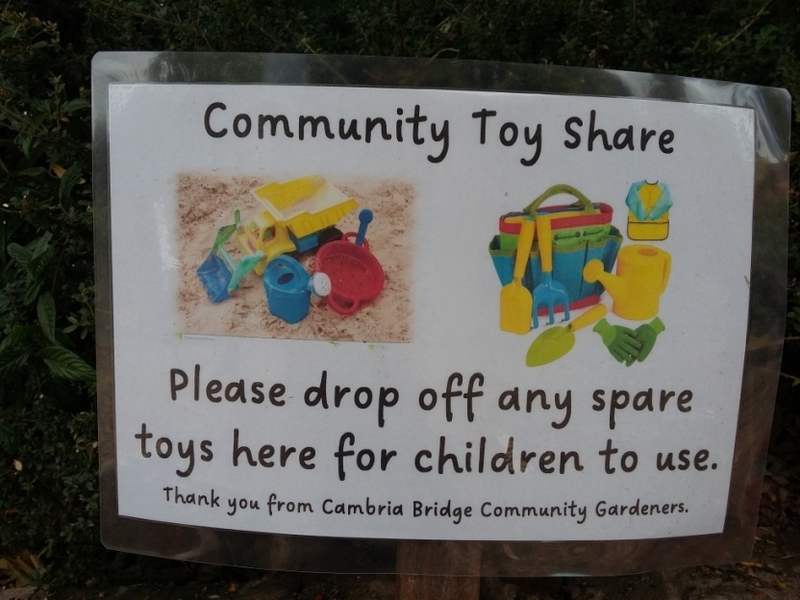 Sign: 'Community toy share.  Please drop off any spare toys for children to use'