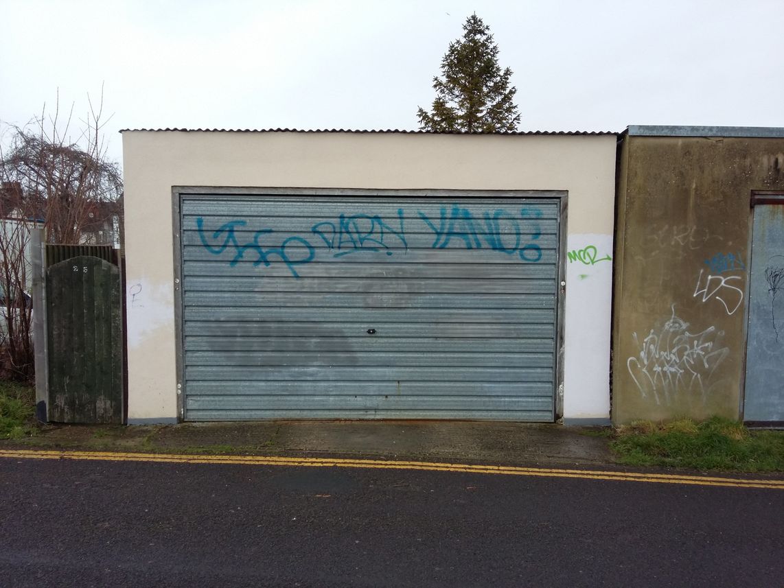 A garage door covered in tags