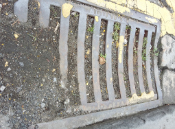 A street drain blocked with mud