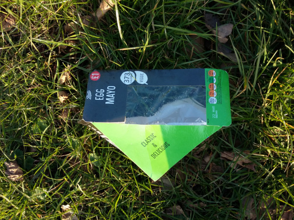 Sandwich packaging littered on an area of grass
