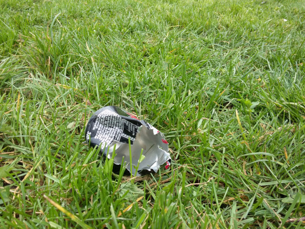 Area of grass with a serated can that has been sliced by a mower