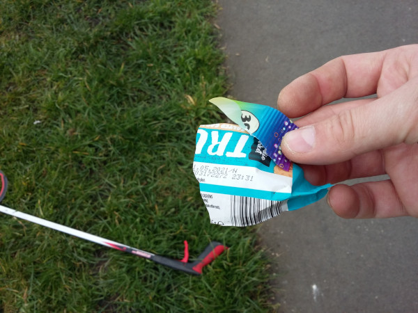 Litter picker holding a razor sharp piece of a can
