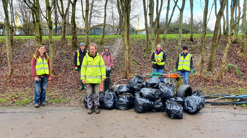 Litter pickers pose next to their rubbish haul