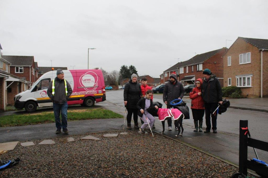 Westlea litter pickers standing in a group by a road and houses