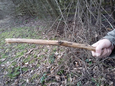 Person holding one end of a stick horizontally