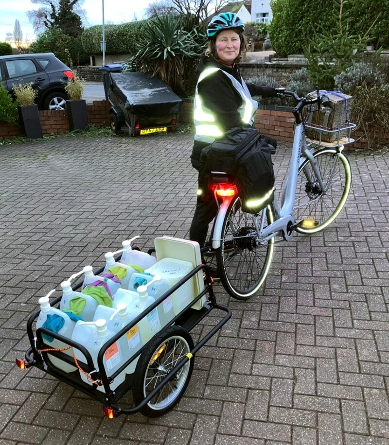 Louise with her electric bike and trailer for refills