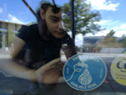 Refill sticker being placed in a window