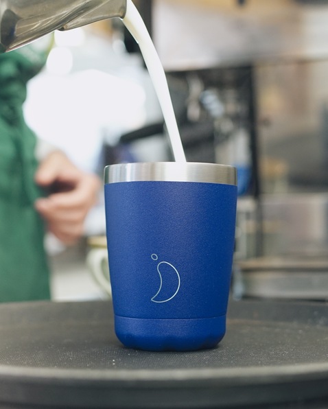 A reusable cup has milk poured into it