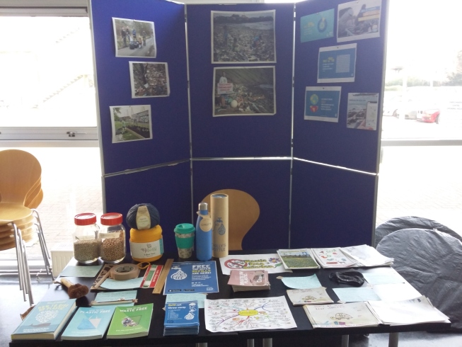 Stall with leaflets, posters, and props at Swindon New College