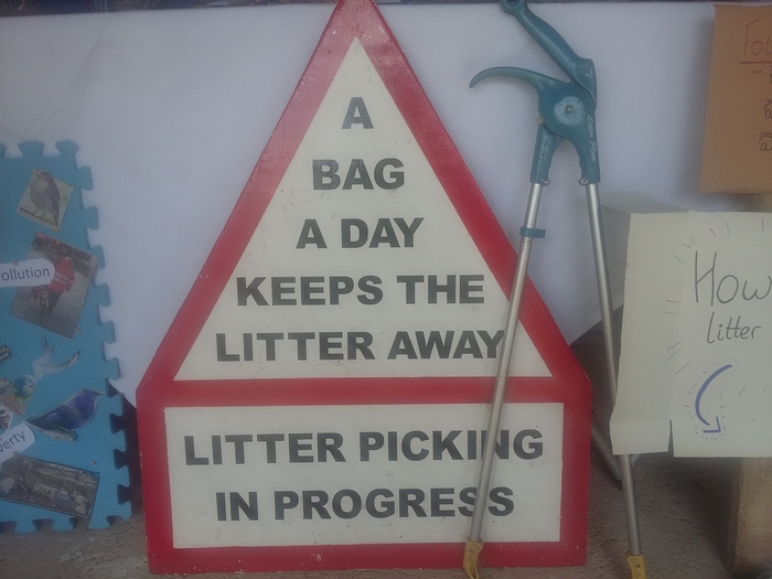 Sign:'A bag a day keeps the litter away.  Litter picking in progress.'