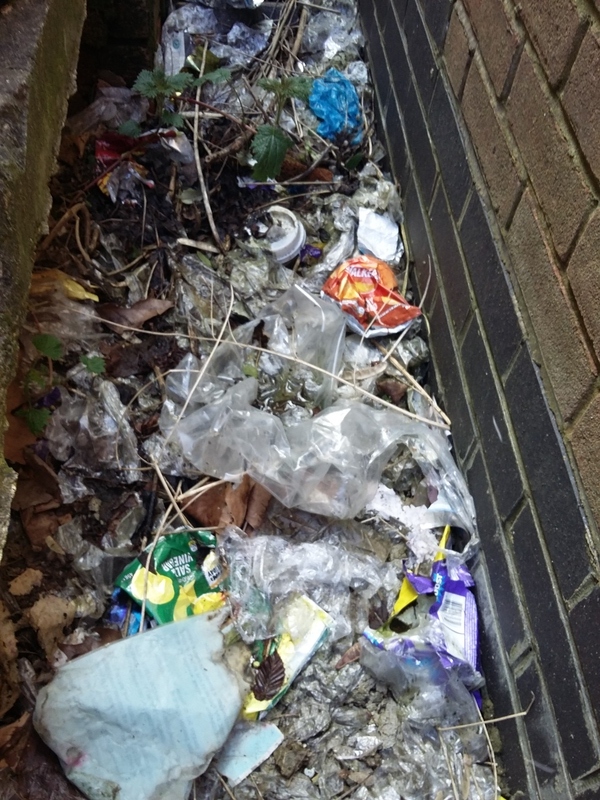 Vast amount of littered plastic behind a petrol station