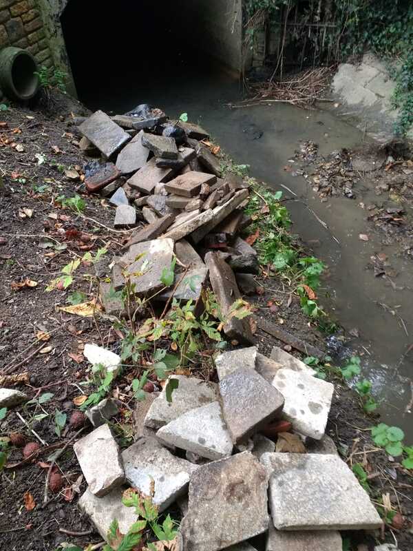 Rubble piled up by river bank