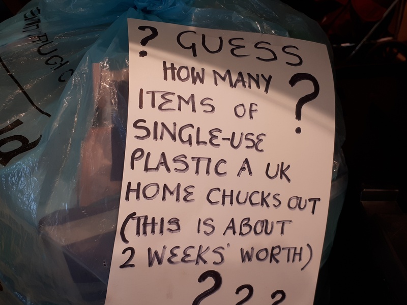 Bag with a sign - how many items of single-use plastics a UK home chucks out in 2 weeks