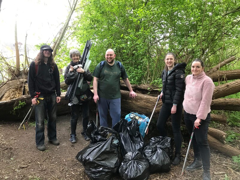 Litter picking group in the park by collected waste