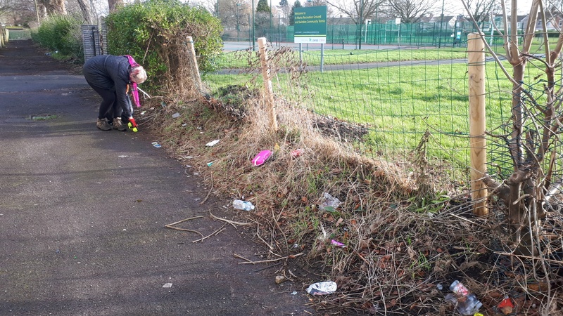 Litter picker clears a heavily littered alleyway