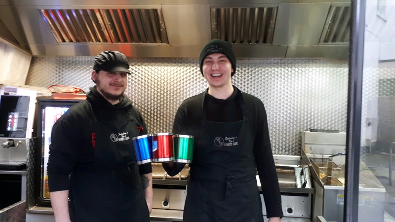 Street Cafe staff holding reusable cups