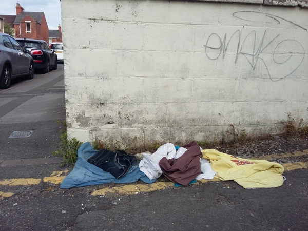 Clothes dumped in an alleway